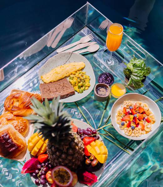 Floating breakfast at amazing hotel villa in blue swimming pool